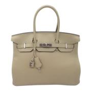 Pre-owned Leather handbags Hermès Vintage , Beige , Dames