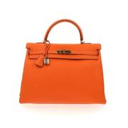 Pre-owned Leather handbags Hermès Vintage , Orange , Dames