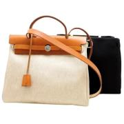 Pre-owned Canvas handbags Hermès Vintage , Beige , Dames