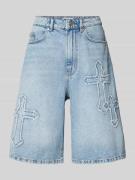 Korte baggy fit jeans met knoop- en ritssluiting